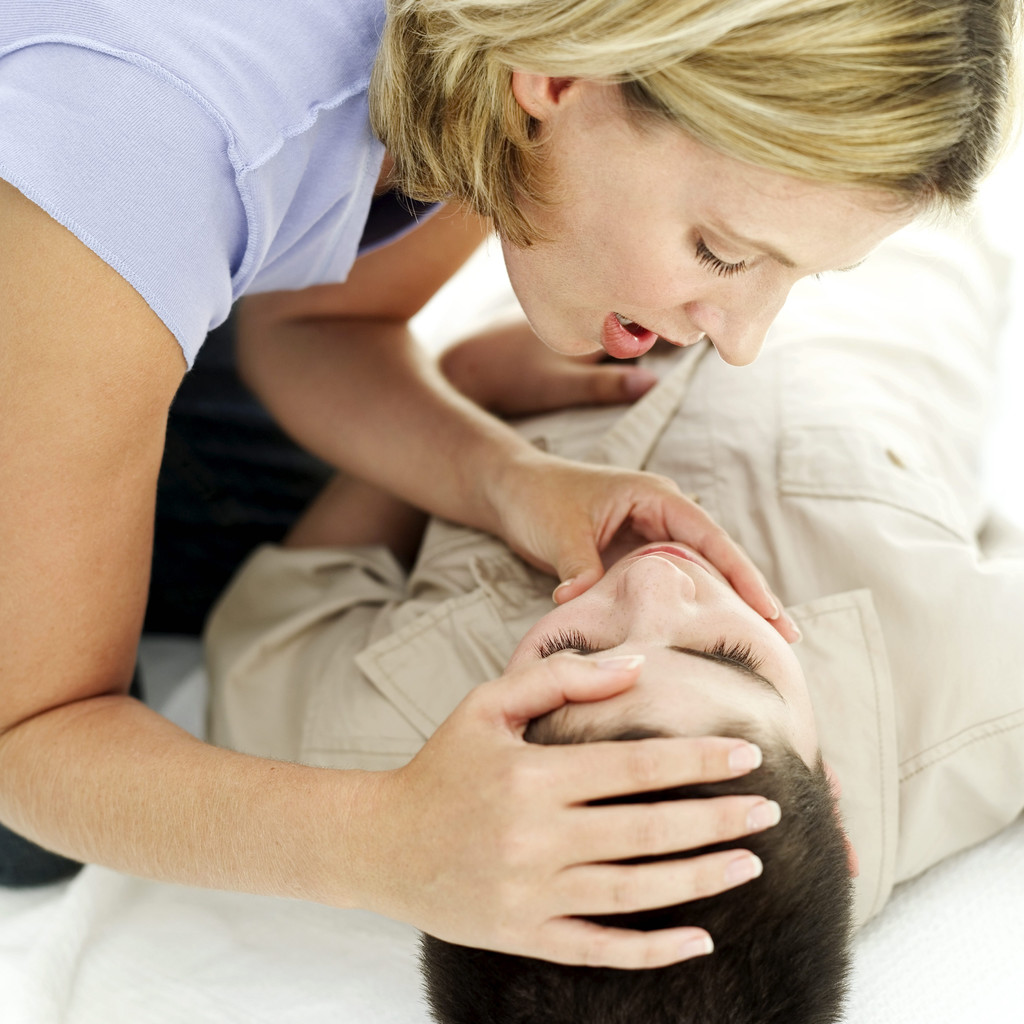 Woman Giving Mouth to Mouth to a Young Boy